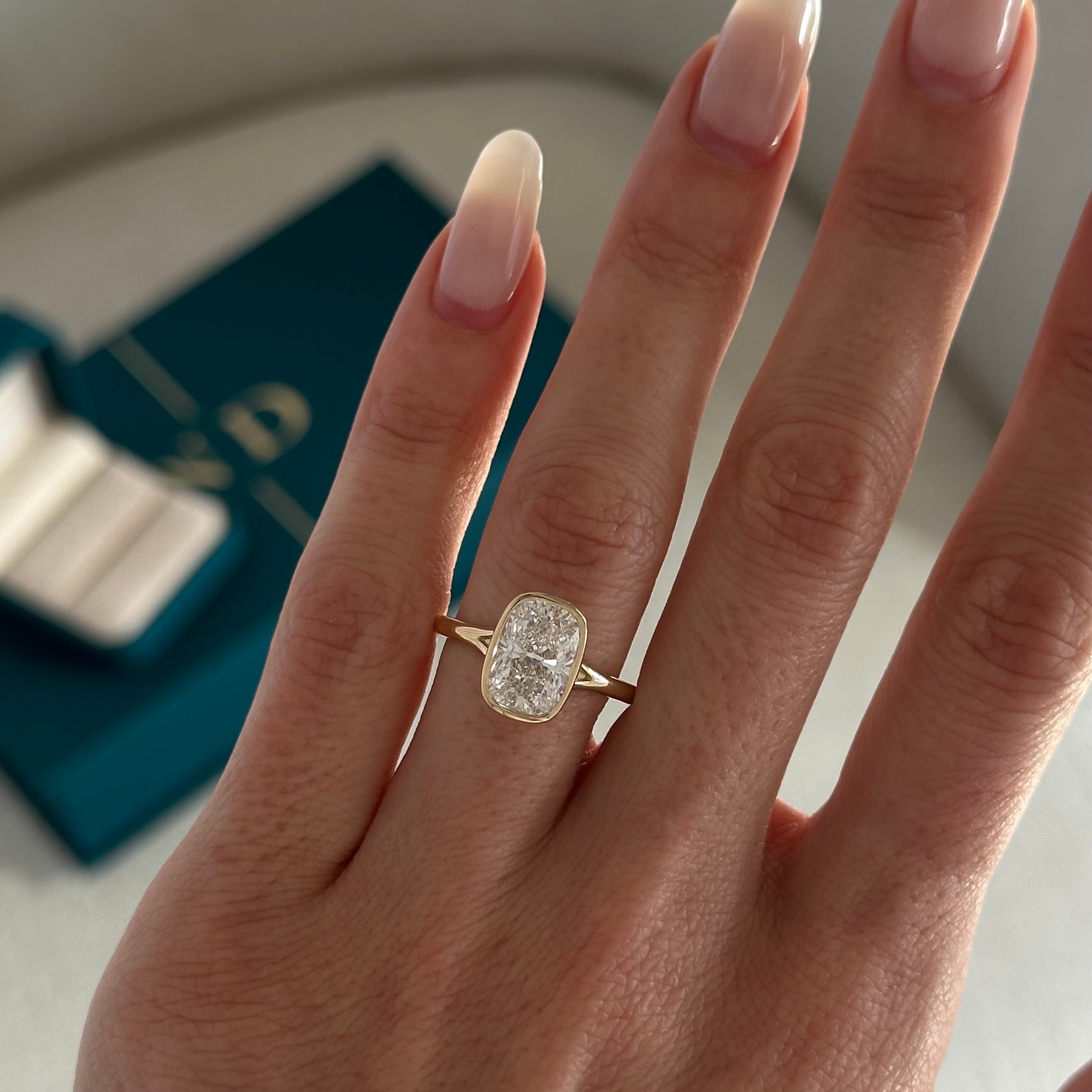 2 carat Elongated Cushion cut lab-grown diamond IGI certified, bezel engagement ring.