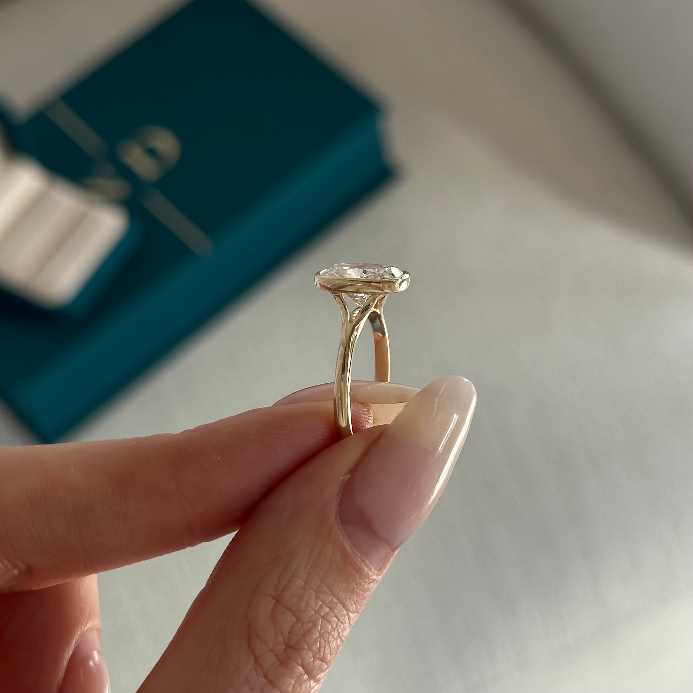 2 carat Elongated Cushion cut lab-grown diamond IGI certified, bezel engagement ring.