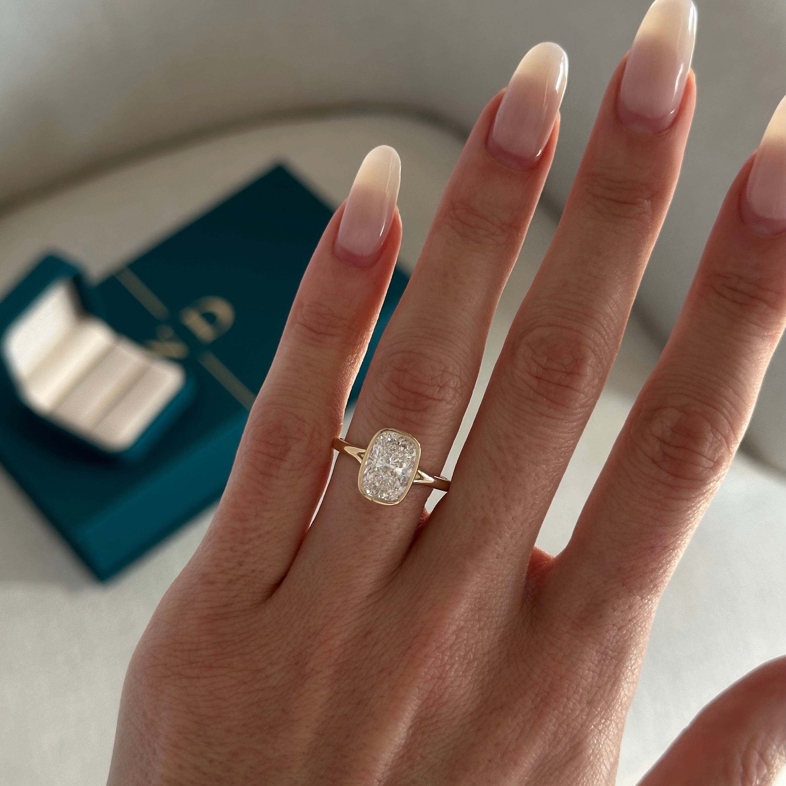 2 carat Elongated Cushion cut lab-grown diamond IGI certified, bezel engagement ring.