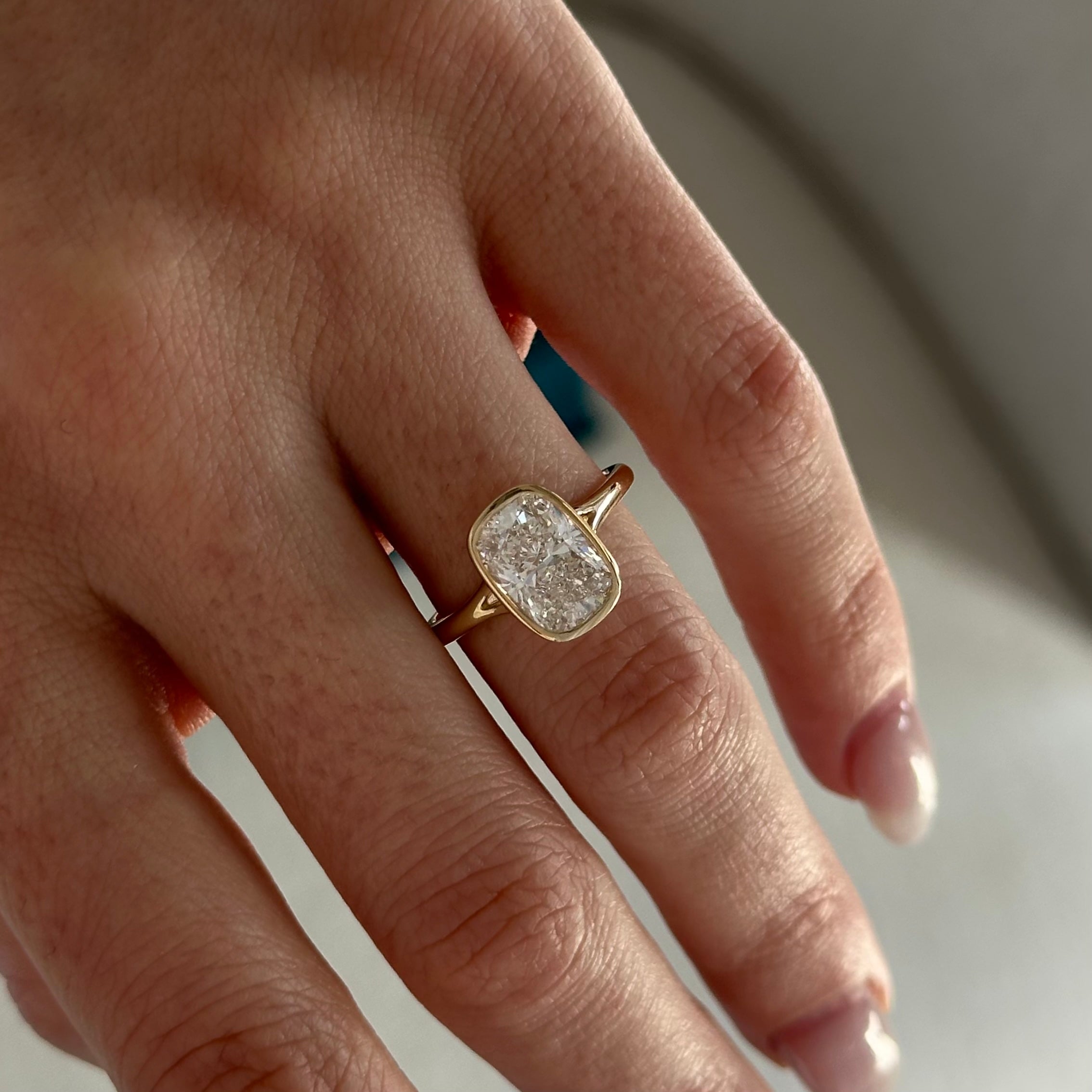 2 carat Elongated Cushion cut lab-grown diamond IGI certified, bezel engagement ring.