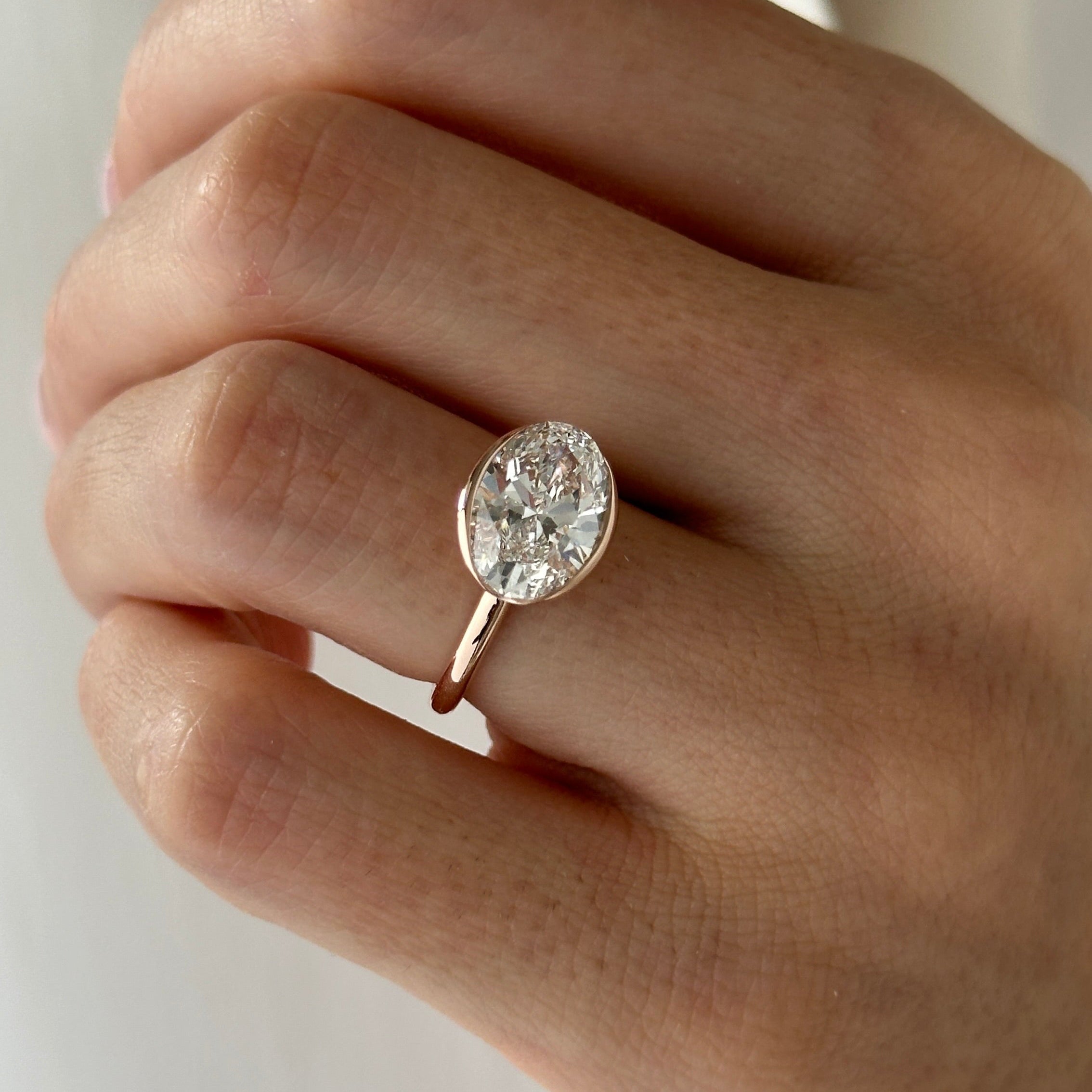 3 carat Oval cut lab-grown diamond IGI certified, bezel engagement ring.