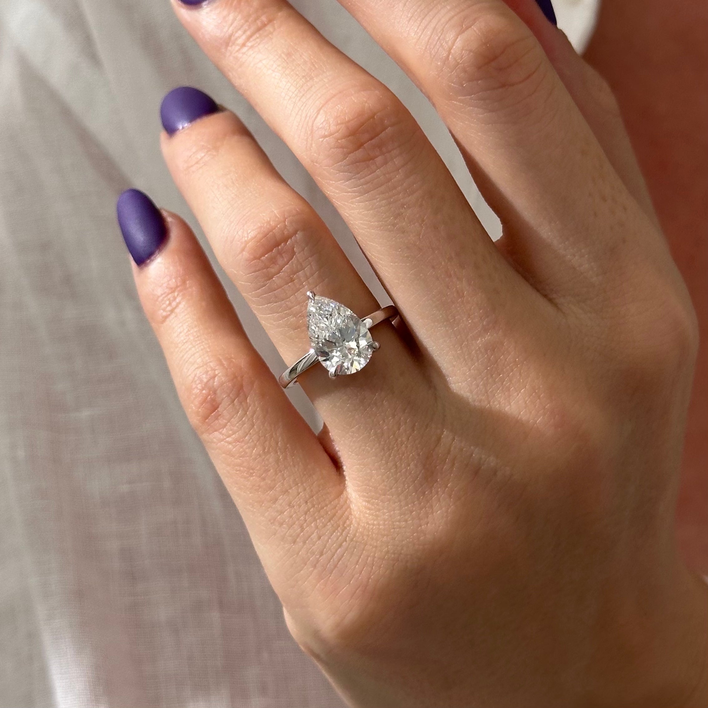 3 carat Pear cut lab-grown diamond IGI certified, hidden halo engagement ring.