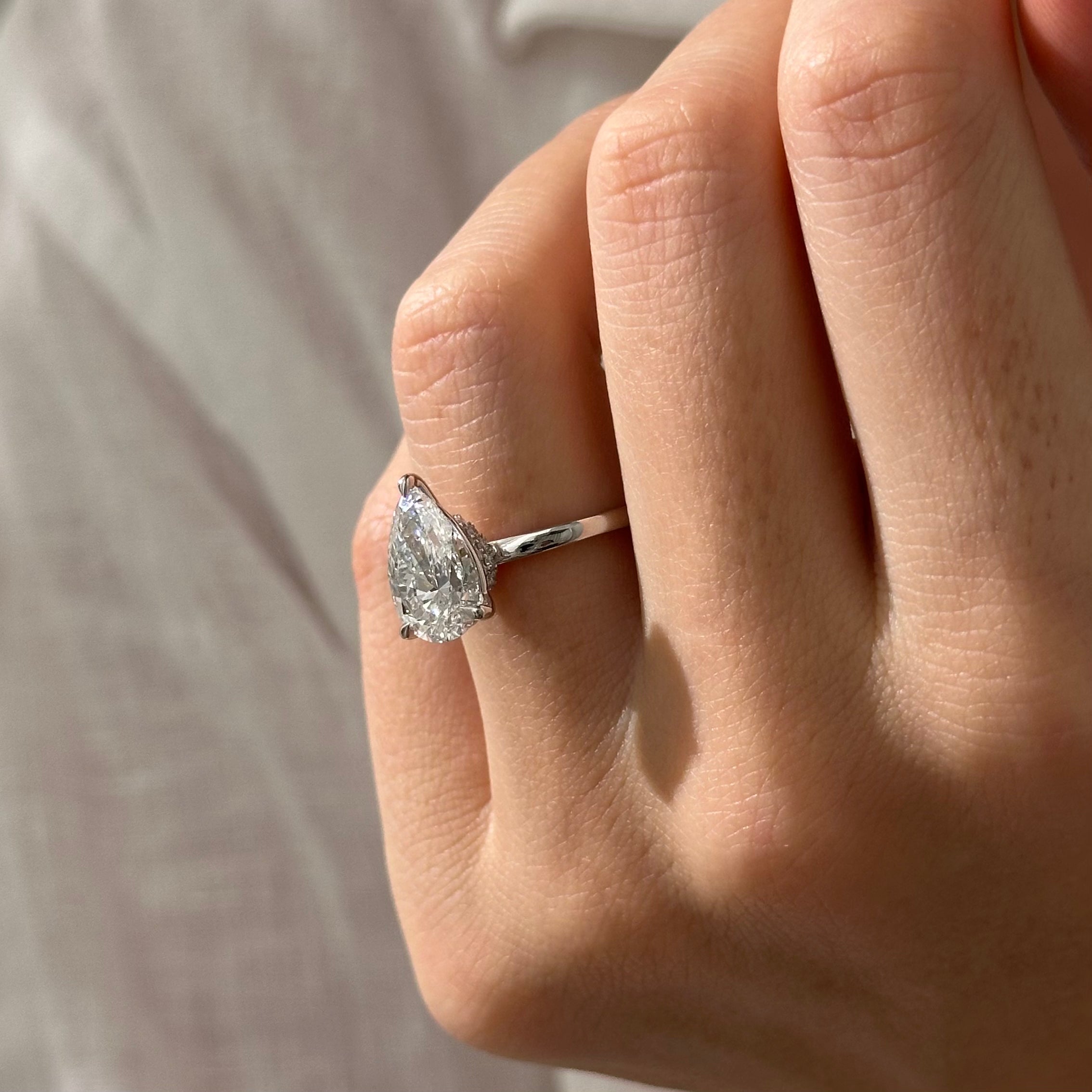 3 carat Pear cut lab-grown diamond IGI certified, hidden halo engagement ring.