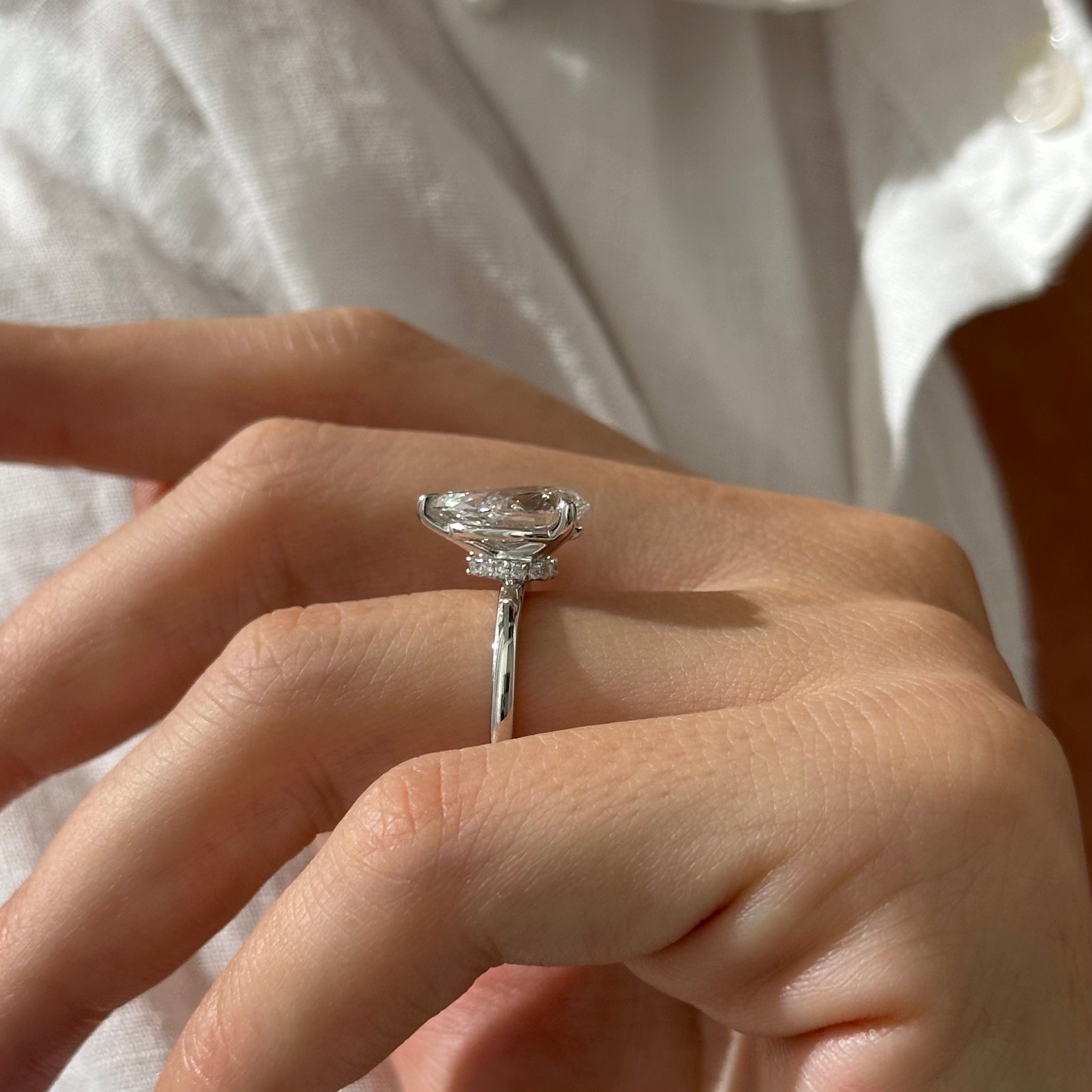3 carat Pear cut lab-grown diamond IGI certified, hidden halo engagement ring.