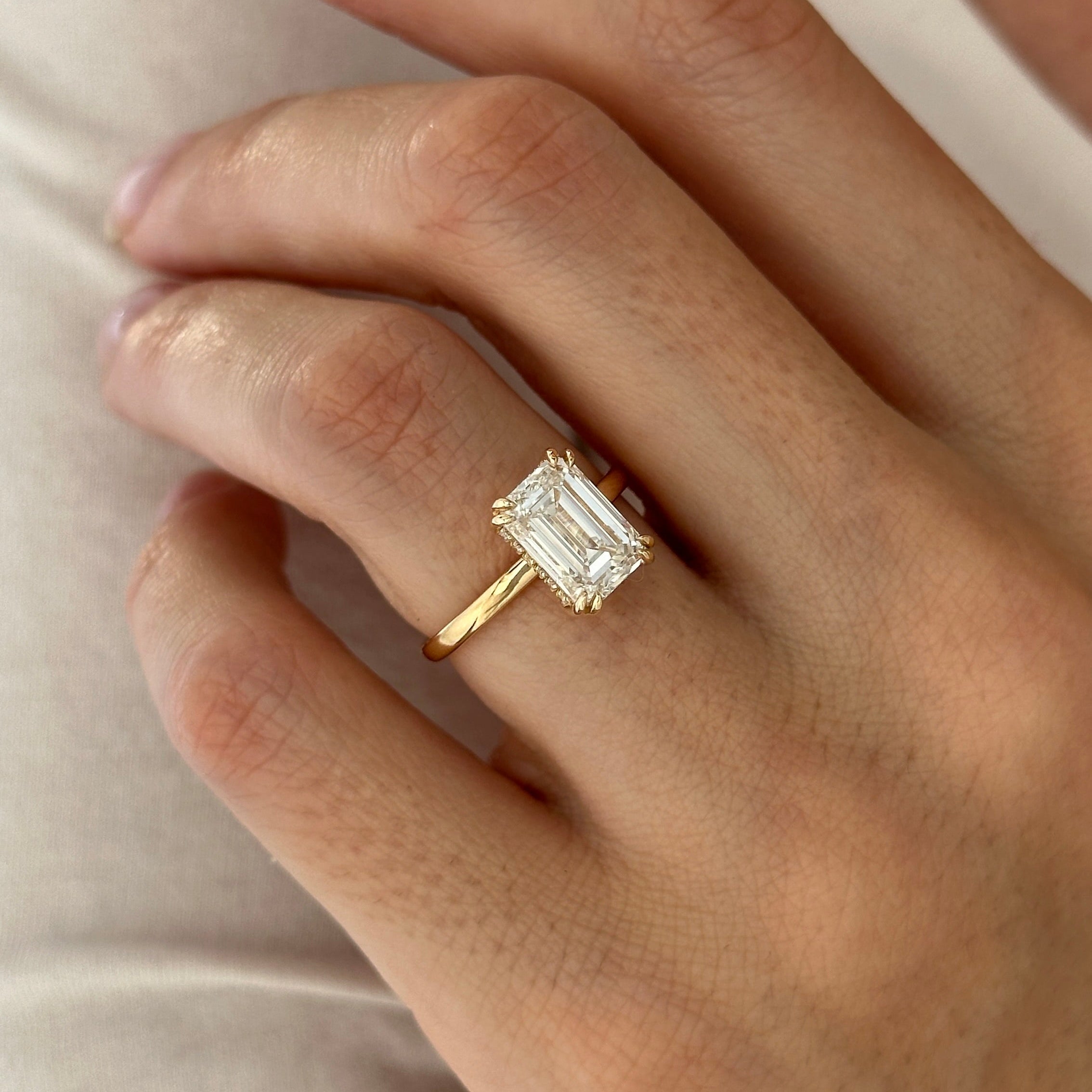 3 carat Emerald cut lab-grown diamond IGI certified, hidden halo engagement ring.