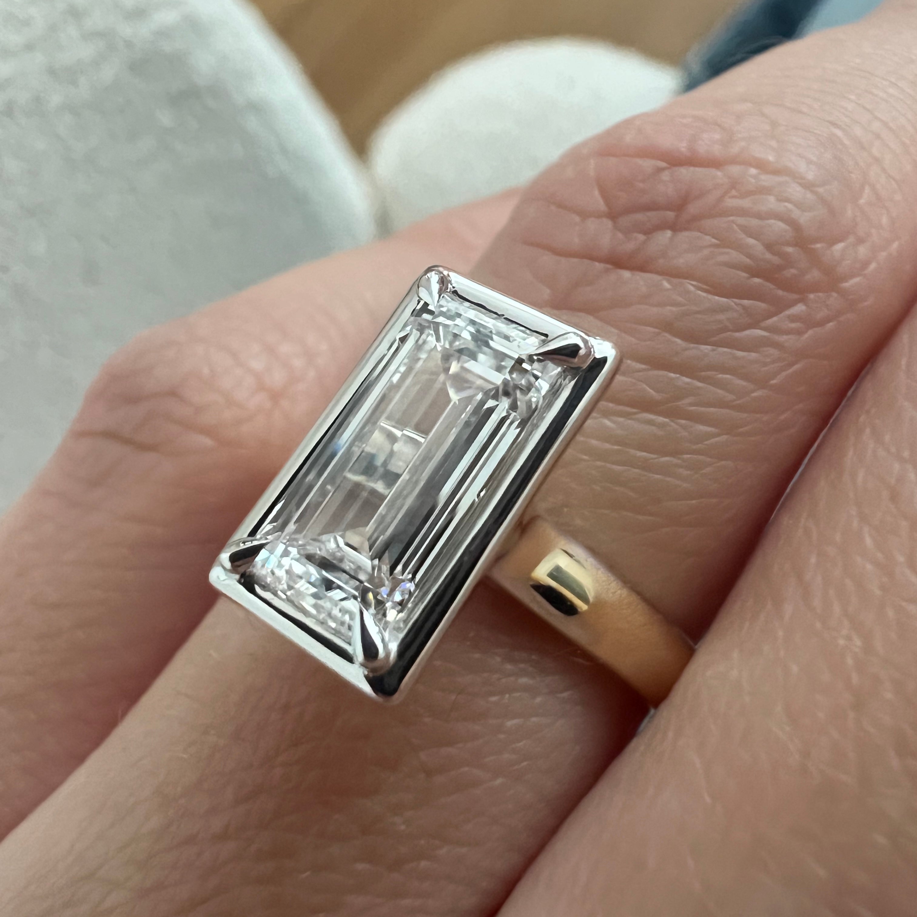 2 carat Oval cut lab-grown diamond IGI certified, bezel engagement ring.