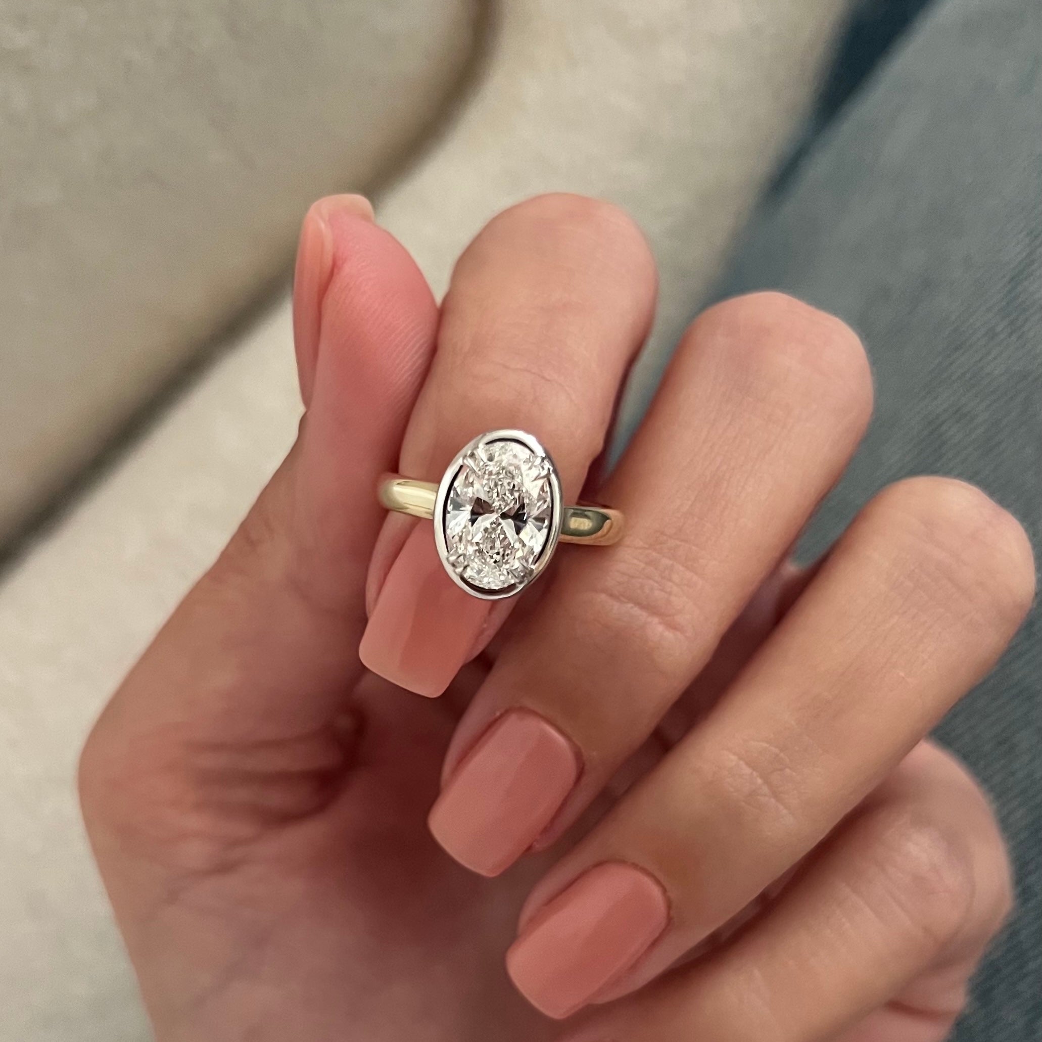 2 carat Oval cut lab-grown diamond IGI certified, bezel engagement ring.