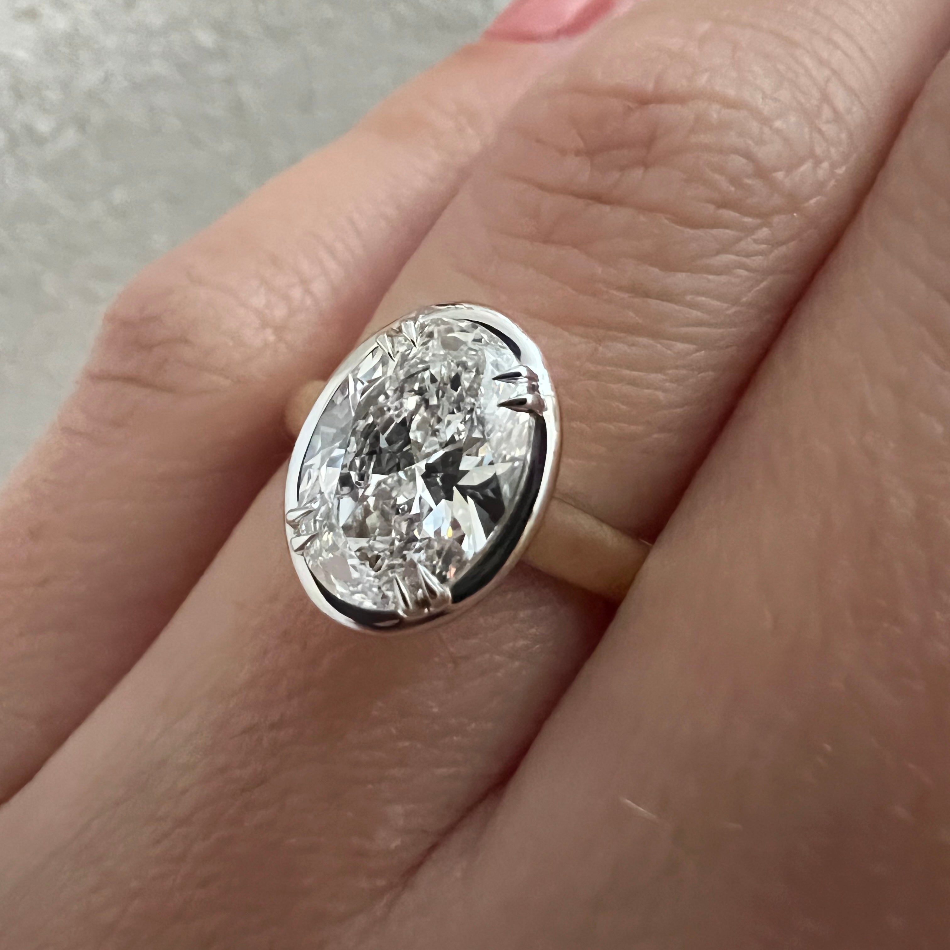 2 carat Oval cut lab-grown diamond IGI certified, bezel engagement ring.