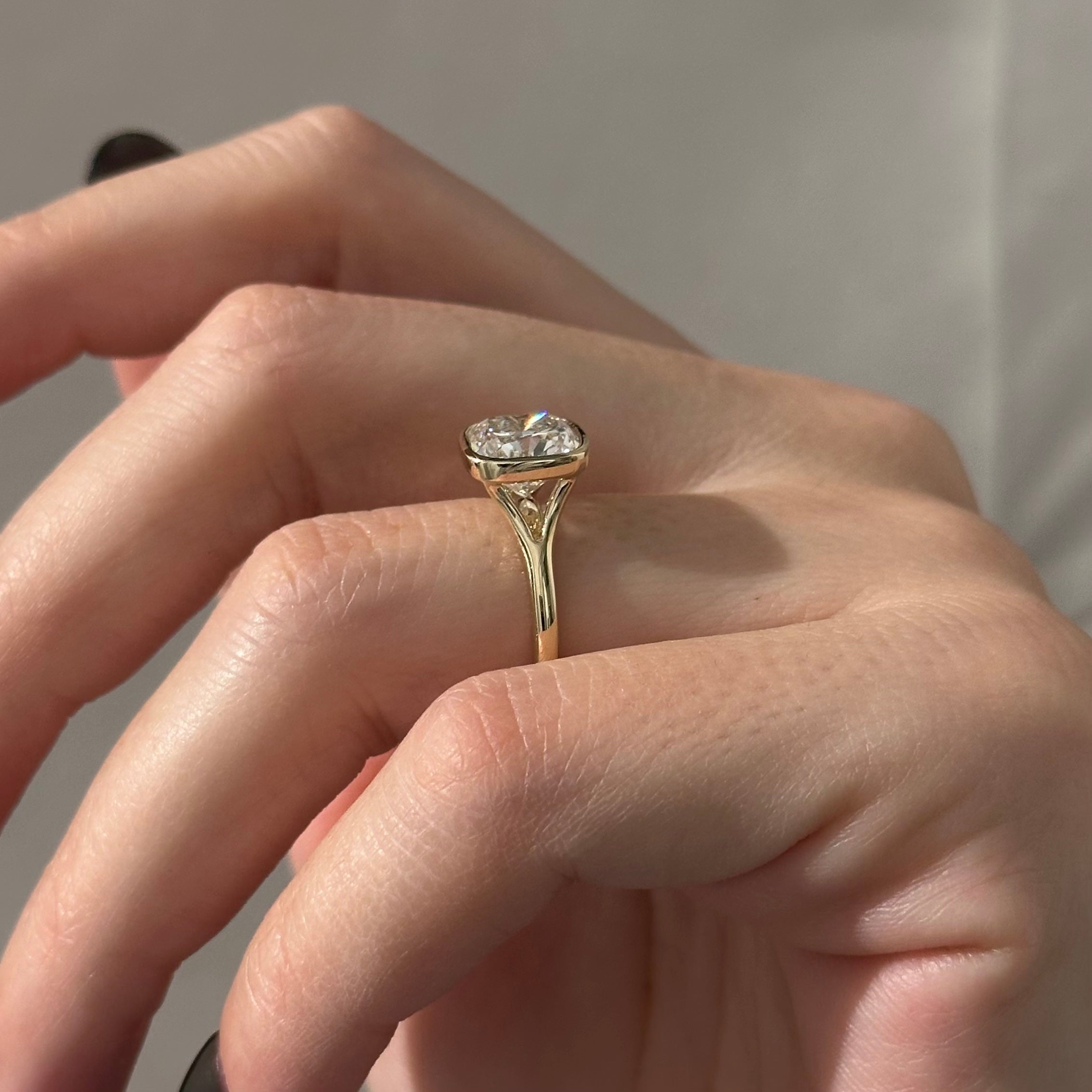 2 carat Cushion cut lab-grown diamond IGI certified, bezel engagement ring.