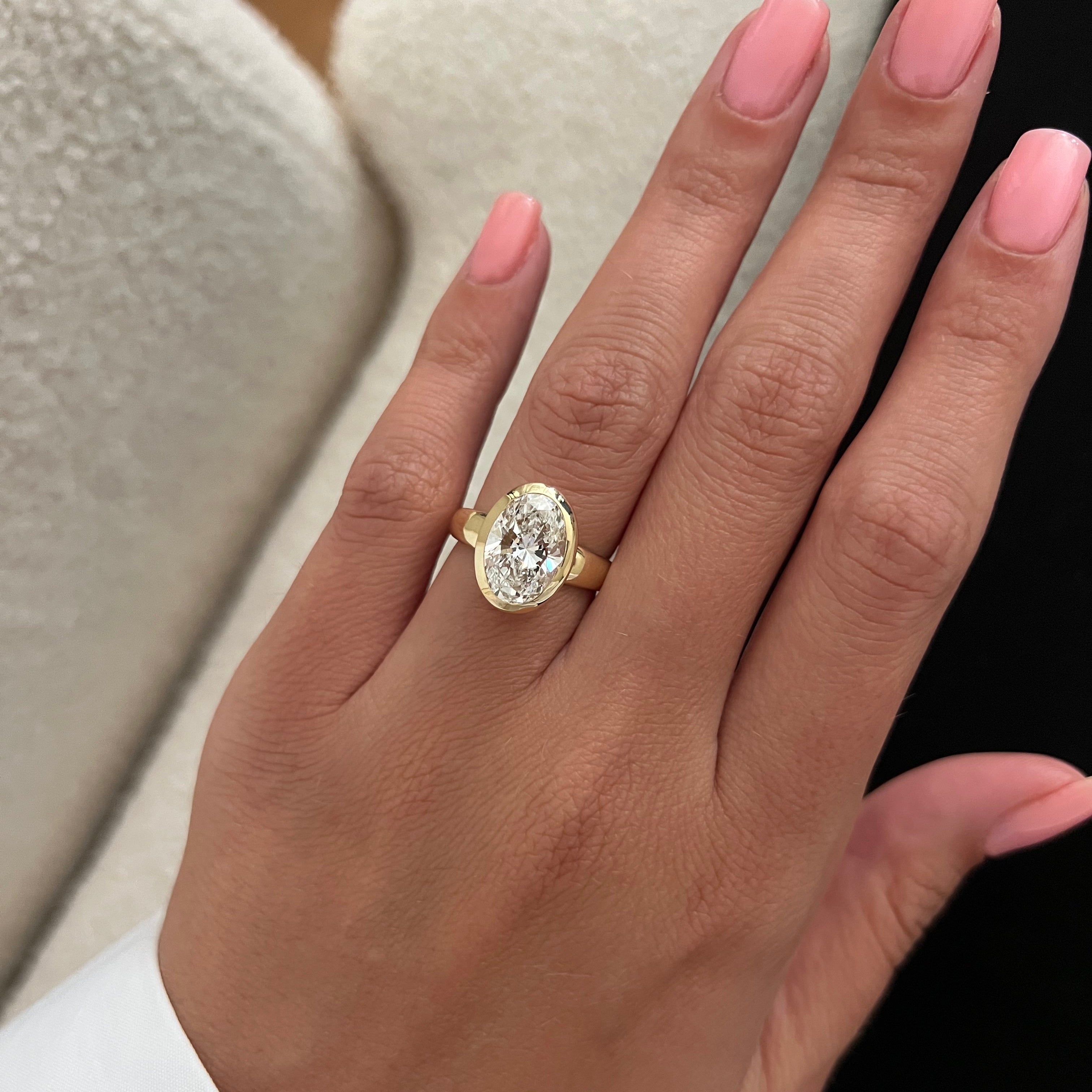 2 carat Oval cut lab-grown diamond IGI certified, bezel engagement ring.
