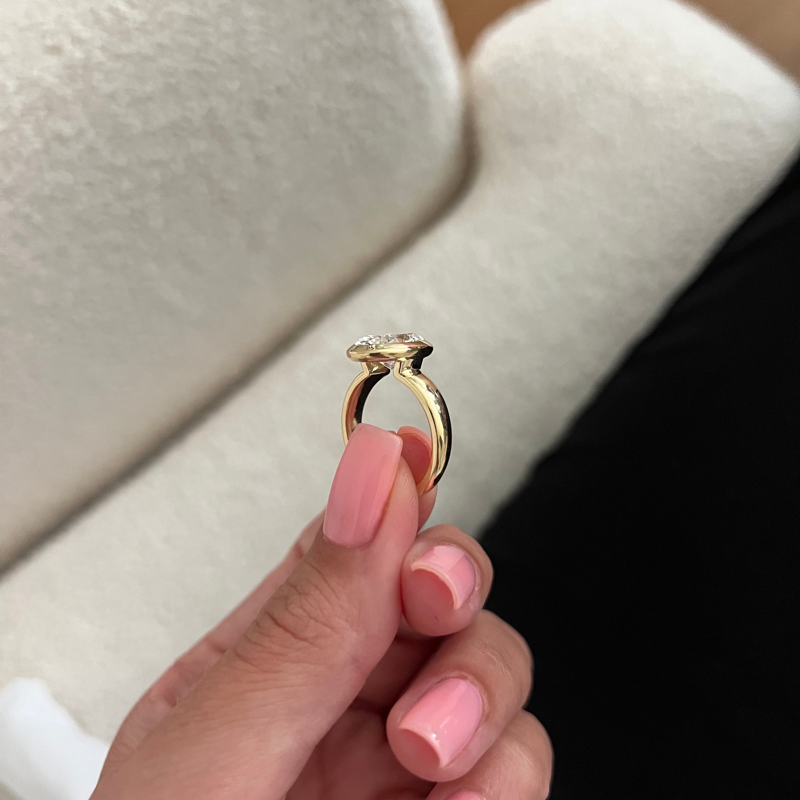 2 carat Oval cut lab-grown diamond IGI certified, bezel engagement ring.