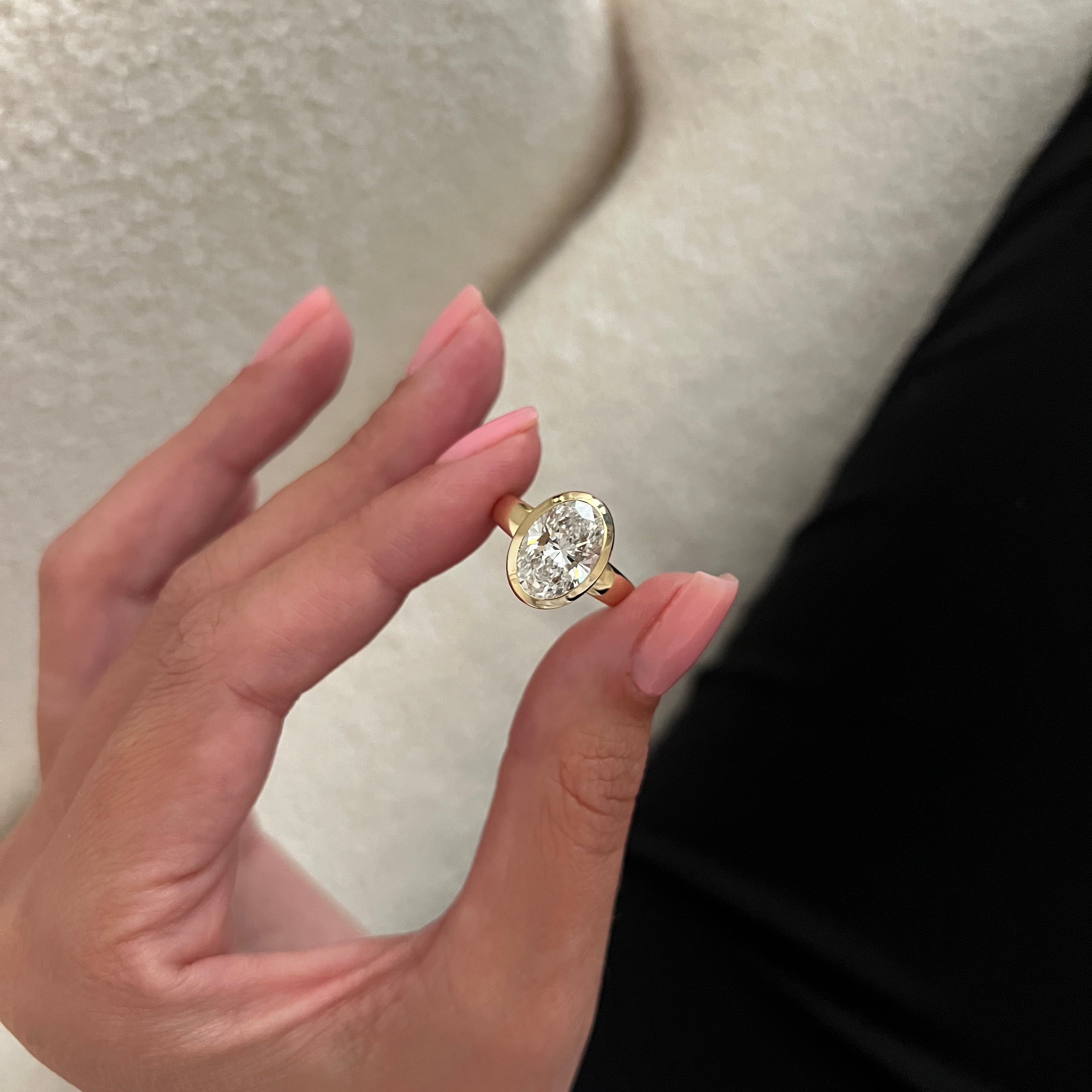 2 carat Oval cut lab-grown diamond IGI certified, bezel engagement ring.