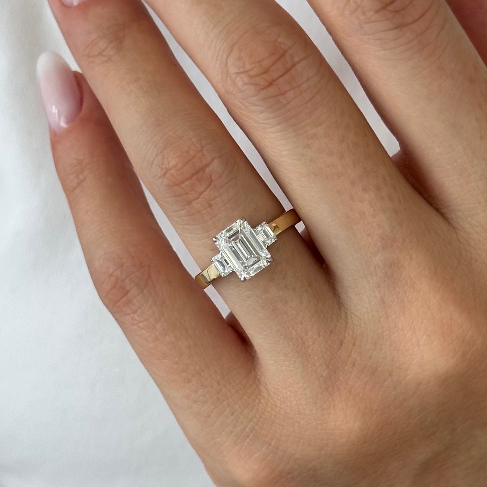 all-groups | 2.25 carat Emerald cut lab-grown diamond IGI certified, three stone engagement ring.