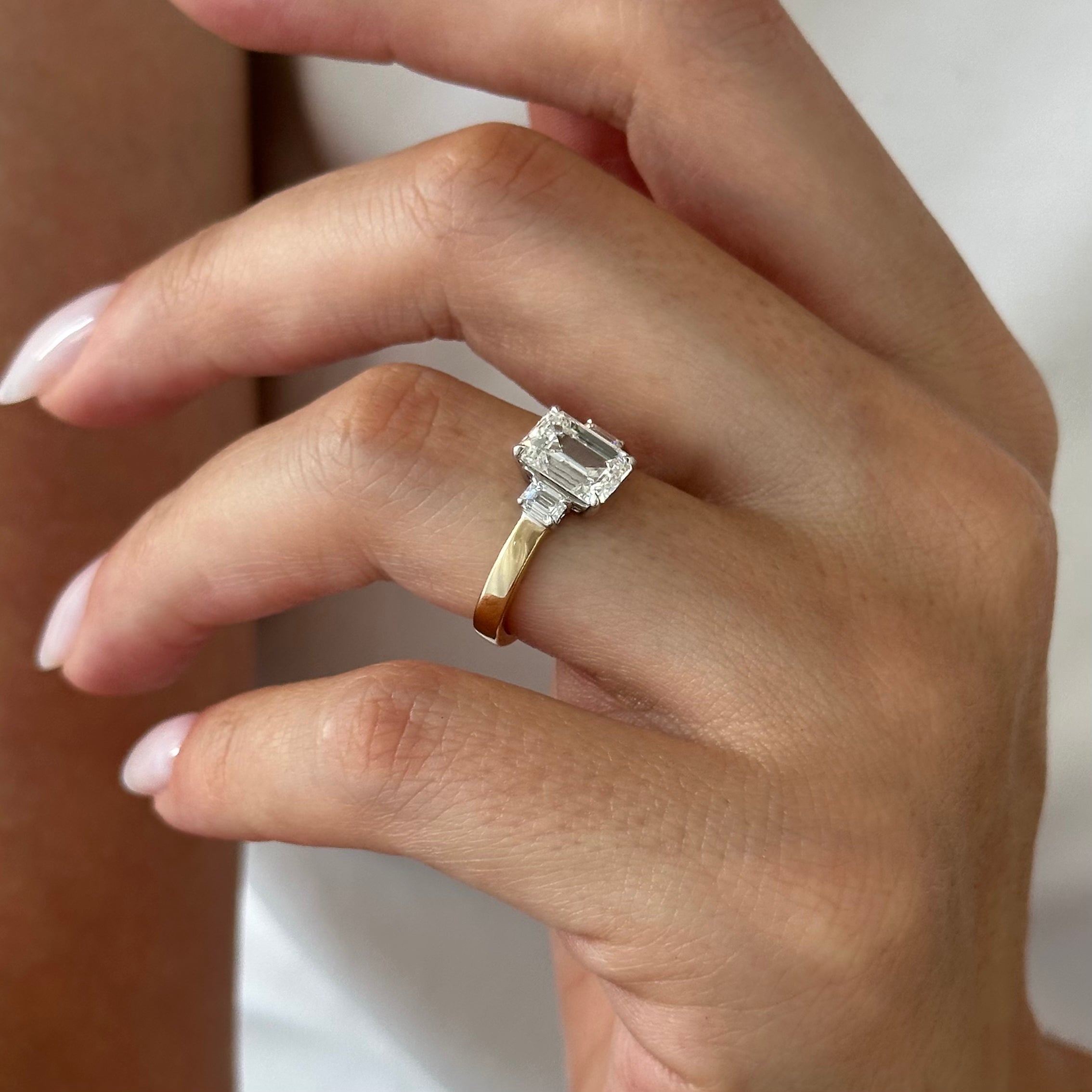all-groups | 2.25 carat Emerald cut lab-grown diamond IGI certified, three stone engagement ring.