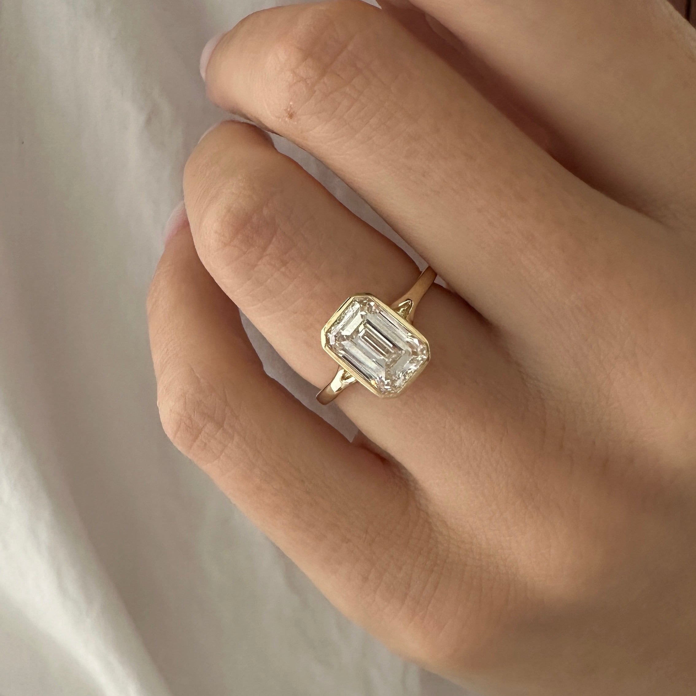 all-groups | 2.5 carat Emerald cut lab-grown diamond IGI certified, bezel engagement ring.