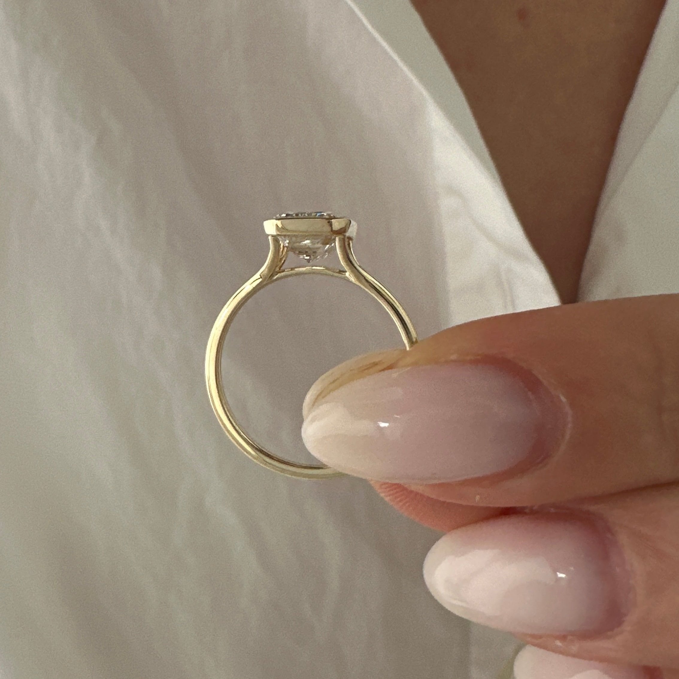 all-groups | 2.5 carat Emerald cut lab-grown diamond IGI certified, bezel engagement ring.
