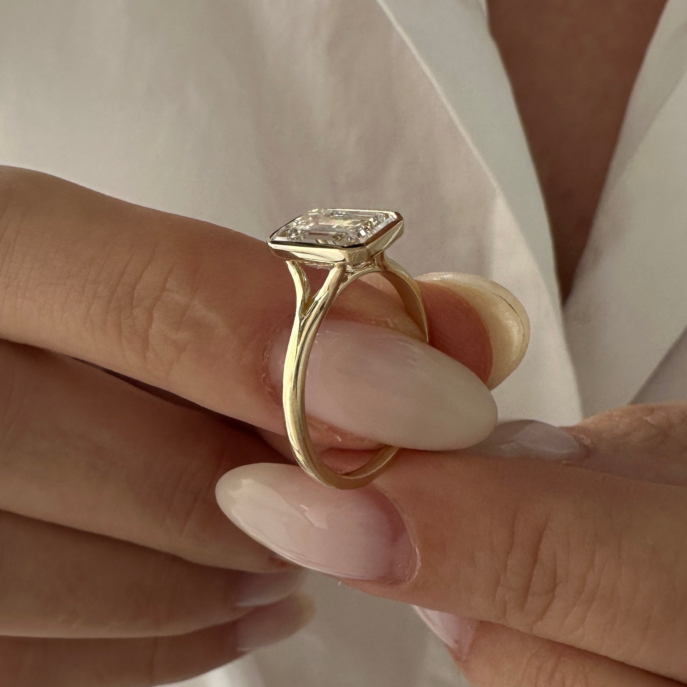 all-groups | 2.5 carat Emerald cut lab-grown diamond IGI certified, bezel engagement ring.