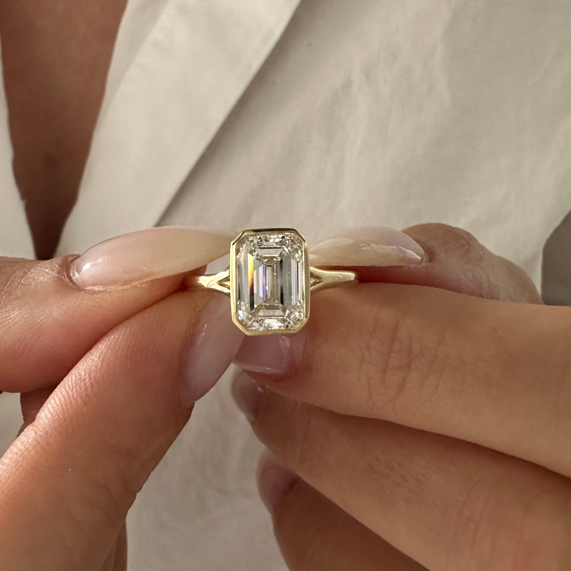 all-groups | 2.5 carat Emerald cut lab-grown diamond IGI certified, bezel engagement ring.