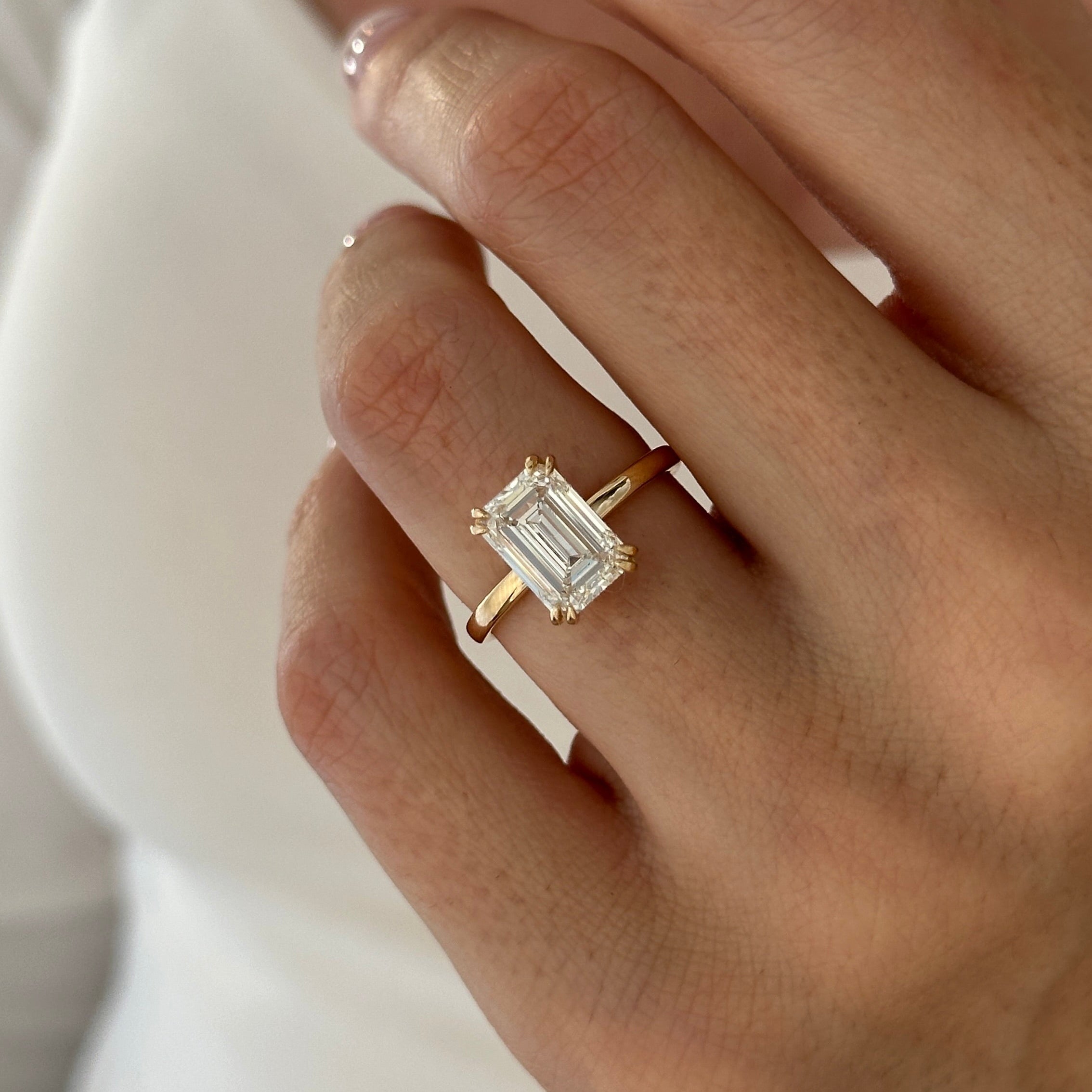 3 carat Emerald cut lab-grown diamond IGI certified, hidden halo engagement ring.