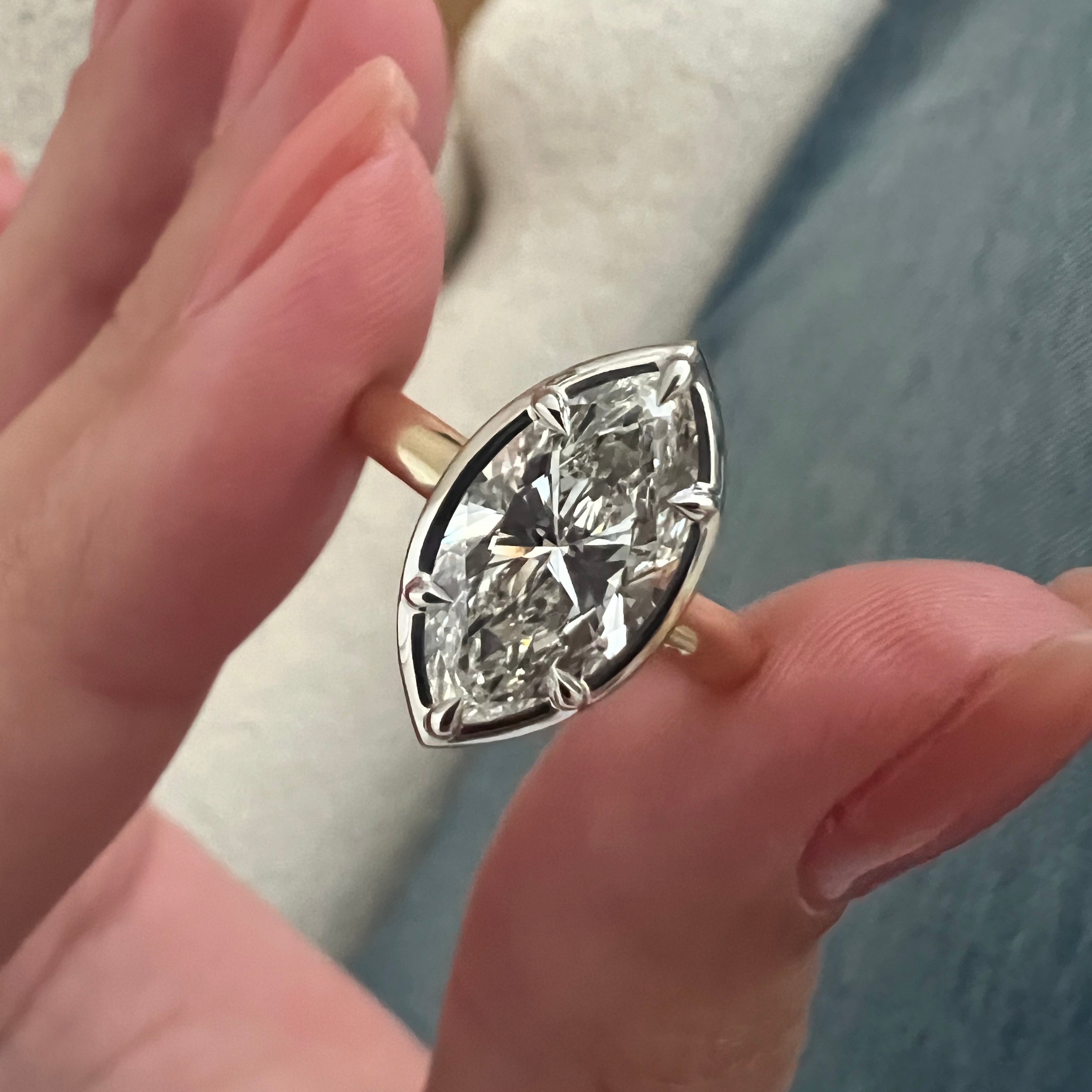 2 carat Oval cut lab-grown diamond IGI certified, bezel engagement ring.