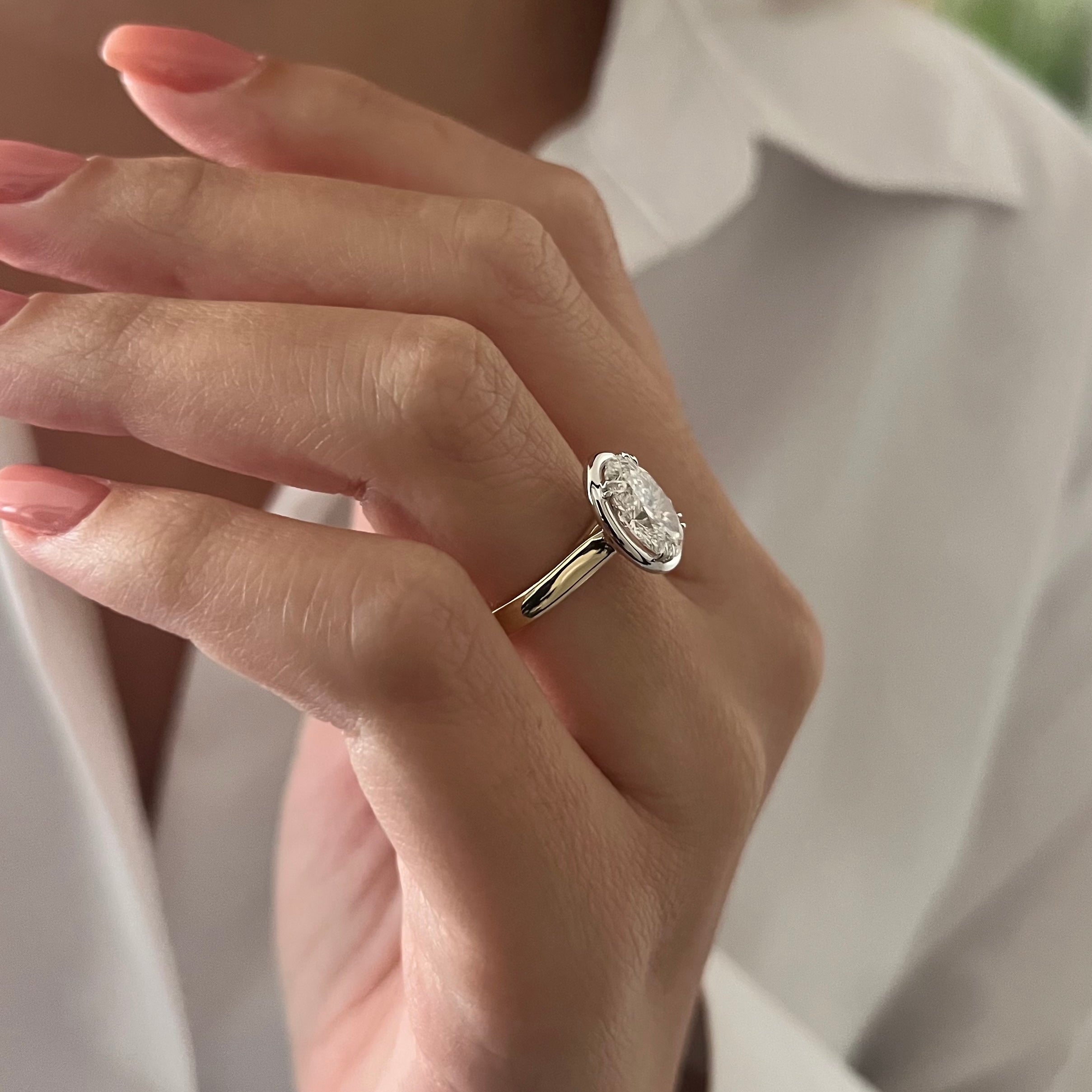 2 carat Oval cut lab-grown diamond IGI certified, bezel engagement ring.