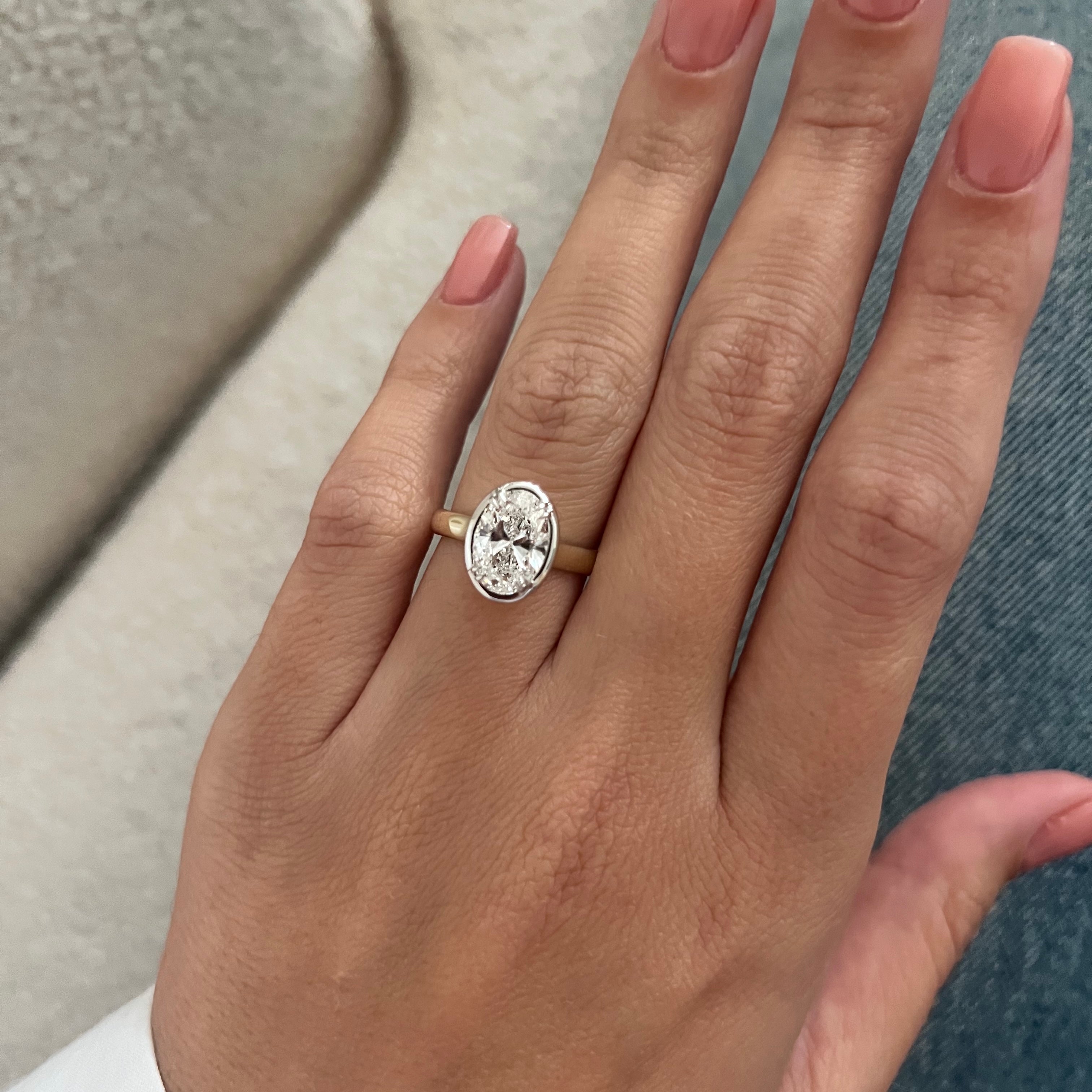 2 carat Oval cut lab-grown diamond IGI certified, bezel engagement ring.