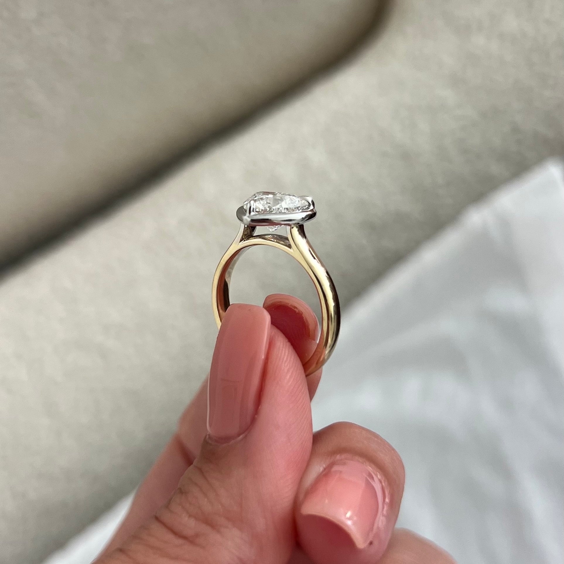 2 carat Oval cut lab-grown diamond IGI certified, bezel engagement ring.
