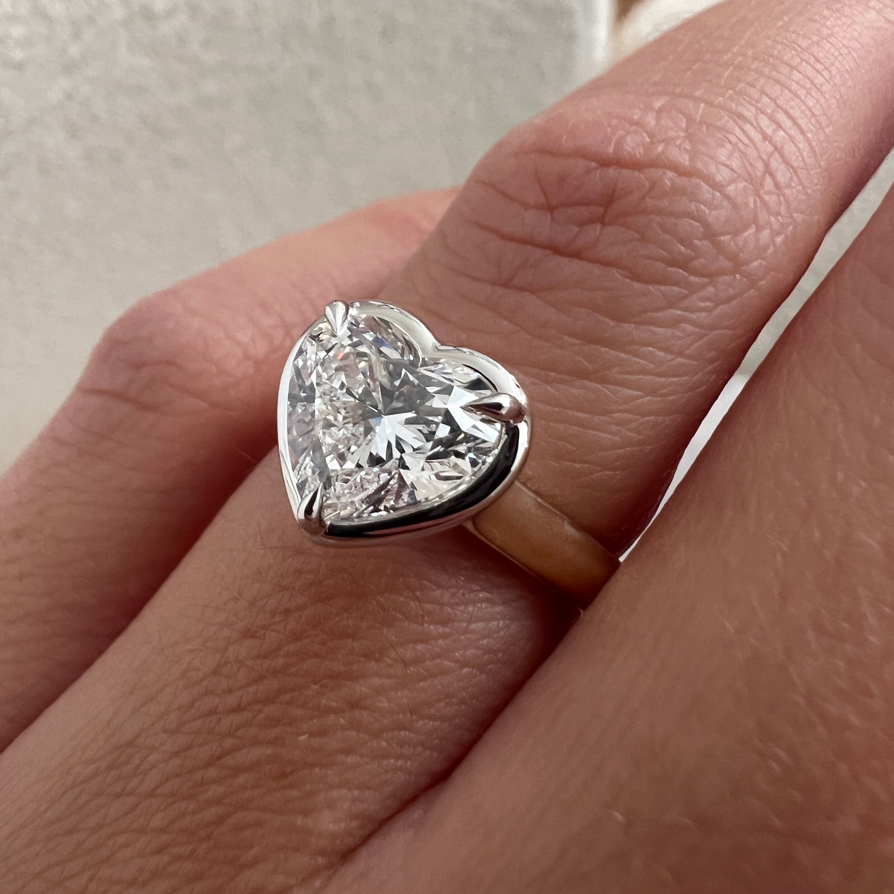 2 carat Oval cut lab-grown diamond IGI certified, bezel engagement ring.