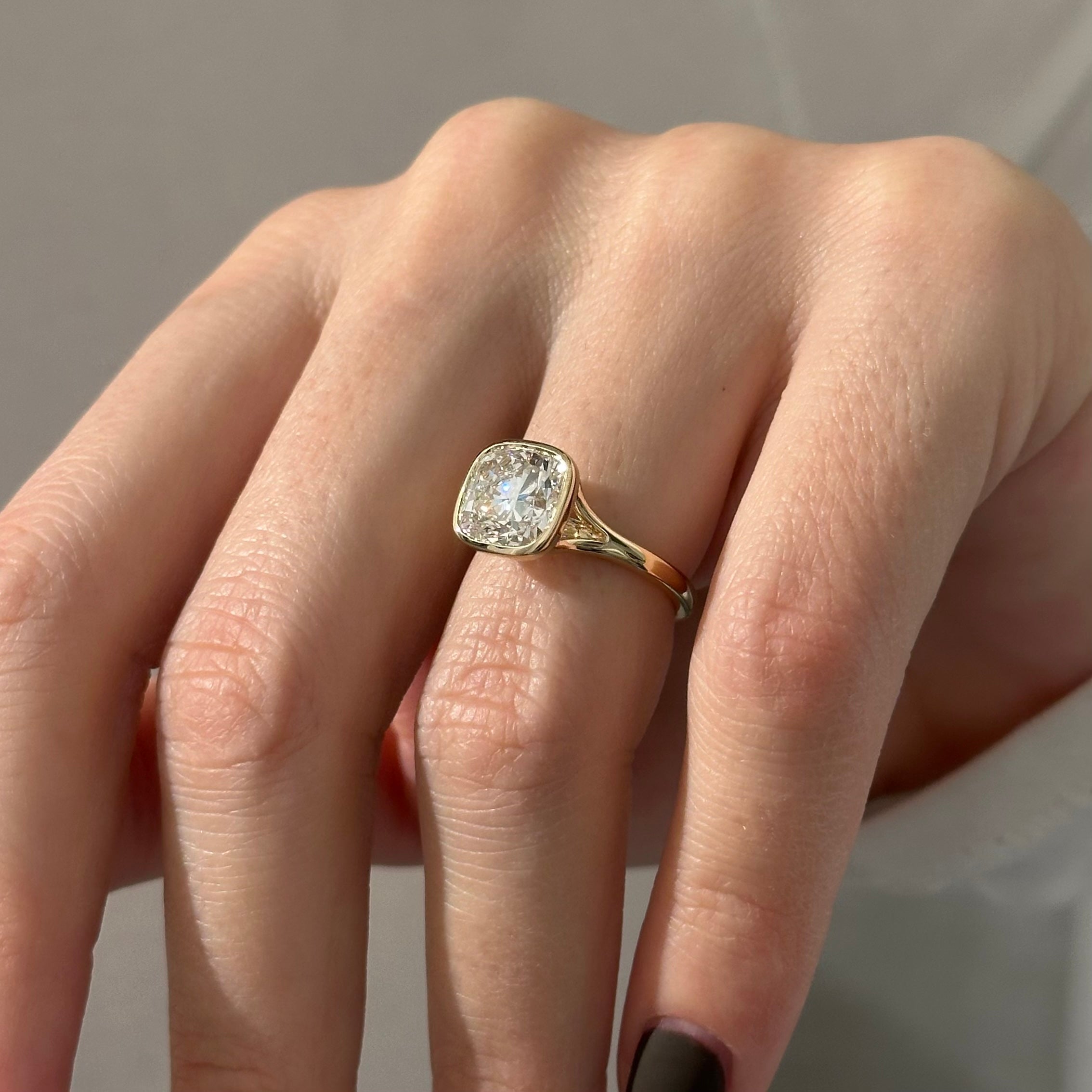 2 carat Cushion cut lab-grown diamond IGI certified, bezel engagement ring.