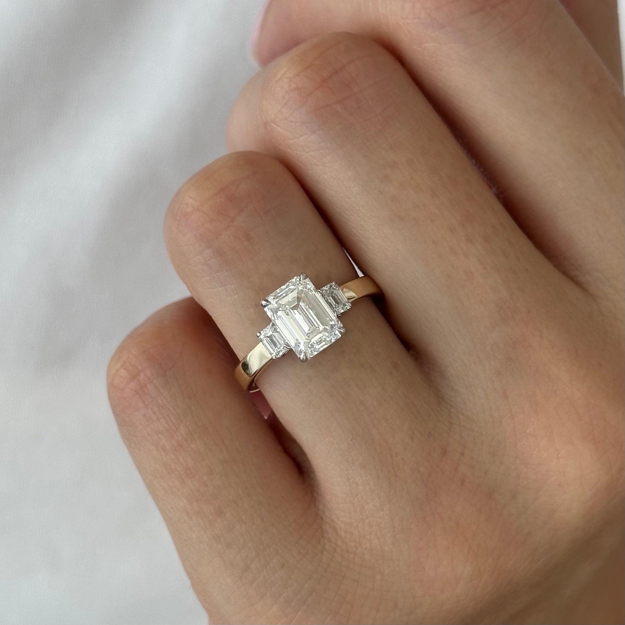 all-groups | 2.25 carat Emerald cut lab-grown diamond IGI certified, three stone engagement ring.