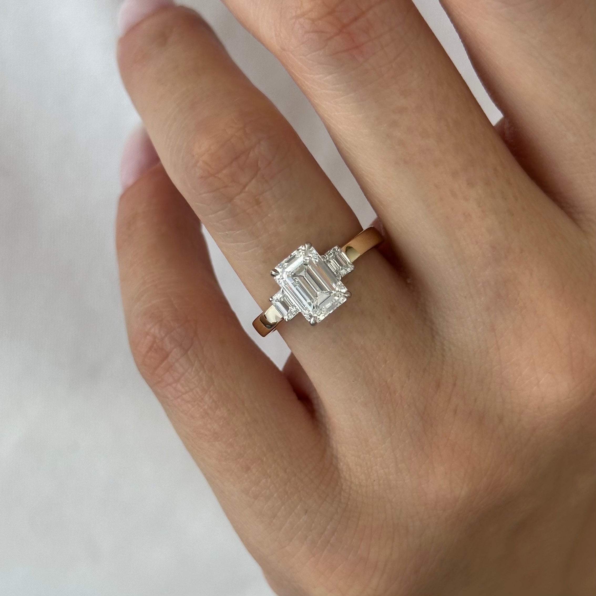 all-groups | 2.25 carat Emerald cut lab-grown diamond IGI certified, three stone engagement ring.