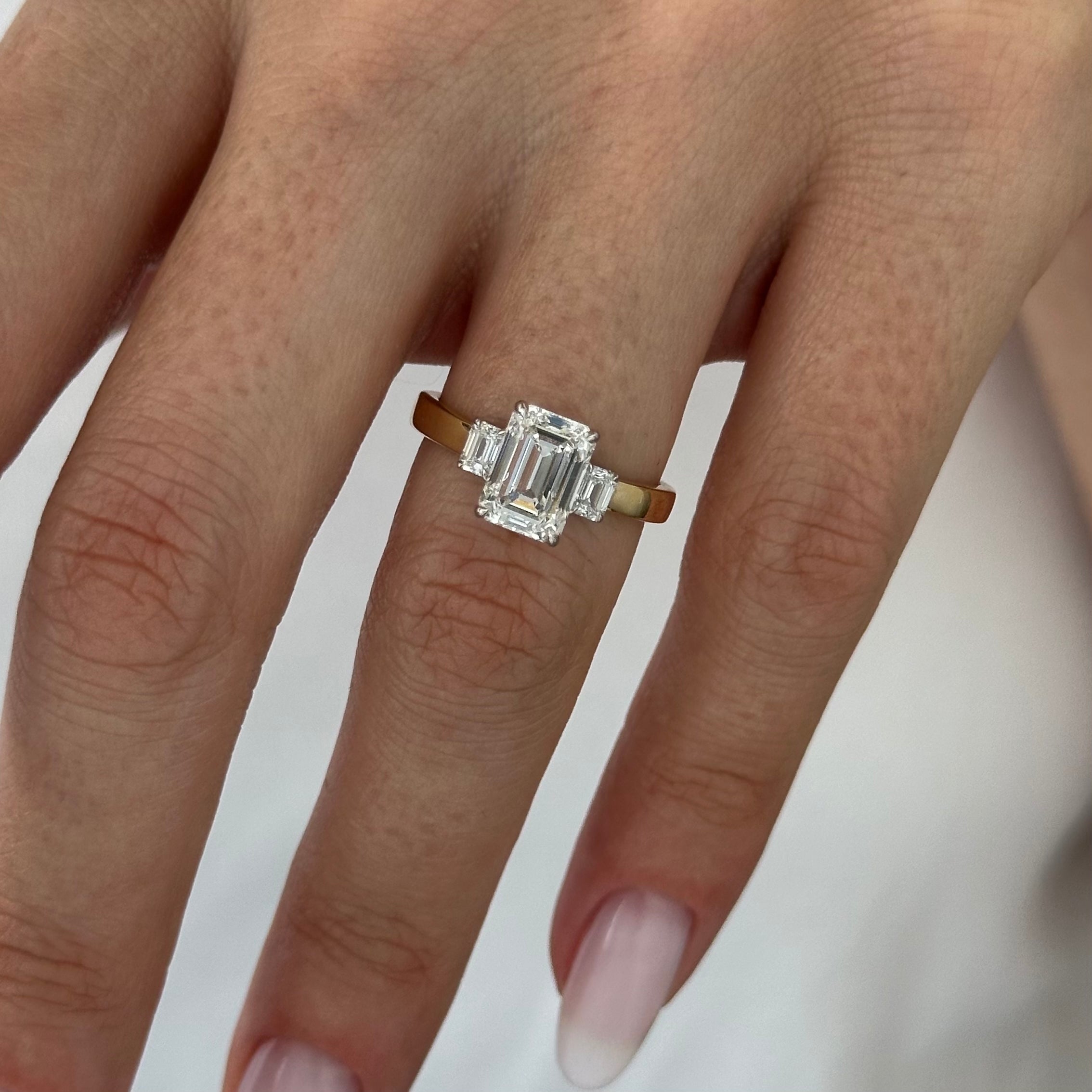 all-groups | 2.25 carat Emerald cut lab-grown diamond IGI certified, three stone engagement ring.