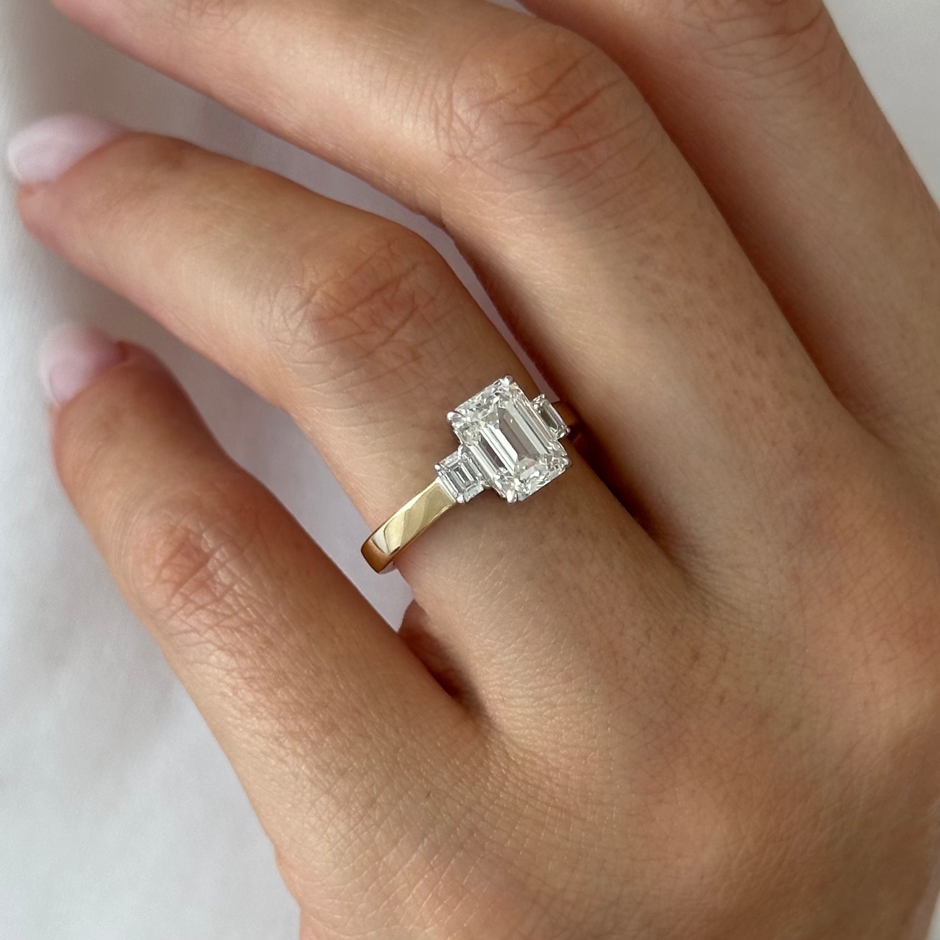 all-groups | 2.25 carat Emerald cut lab-grown diamond IGI certified, three stone engagement ring.