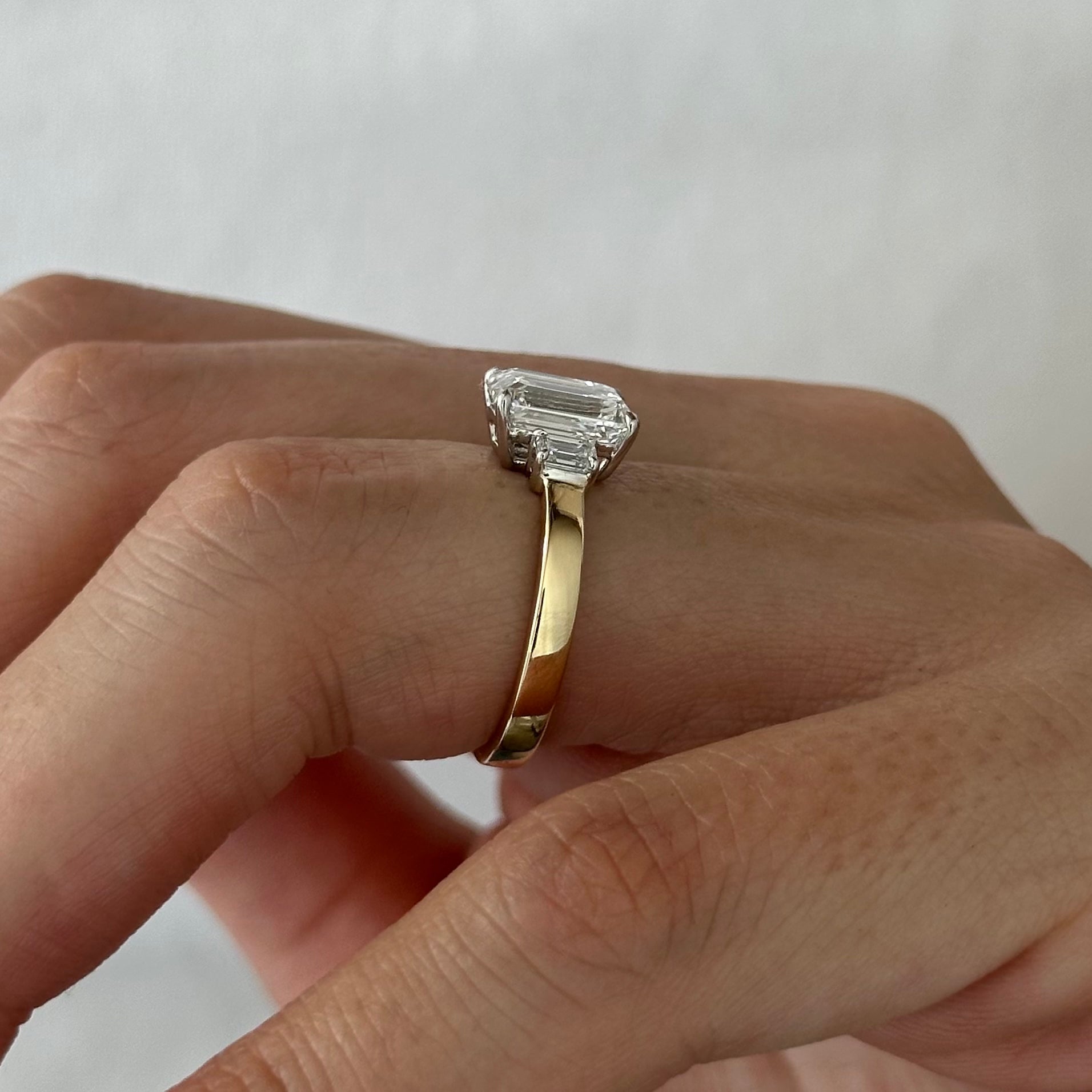 all-groups | 2.25 carat Emerald cut lab-grown diamond IGI certified, three stone engagement ring.