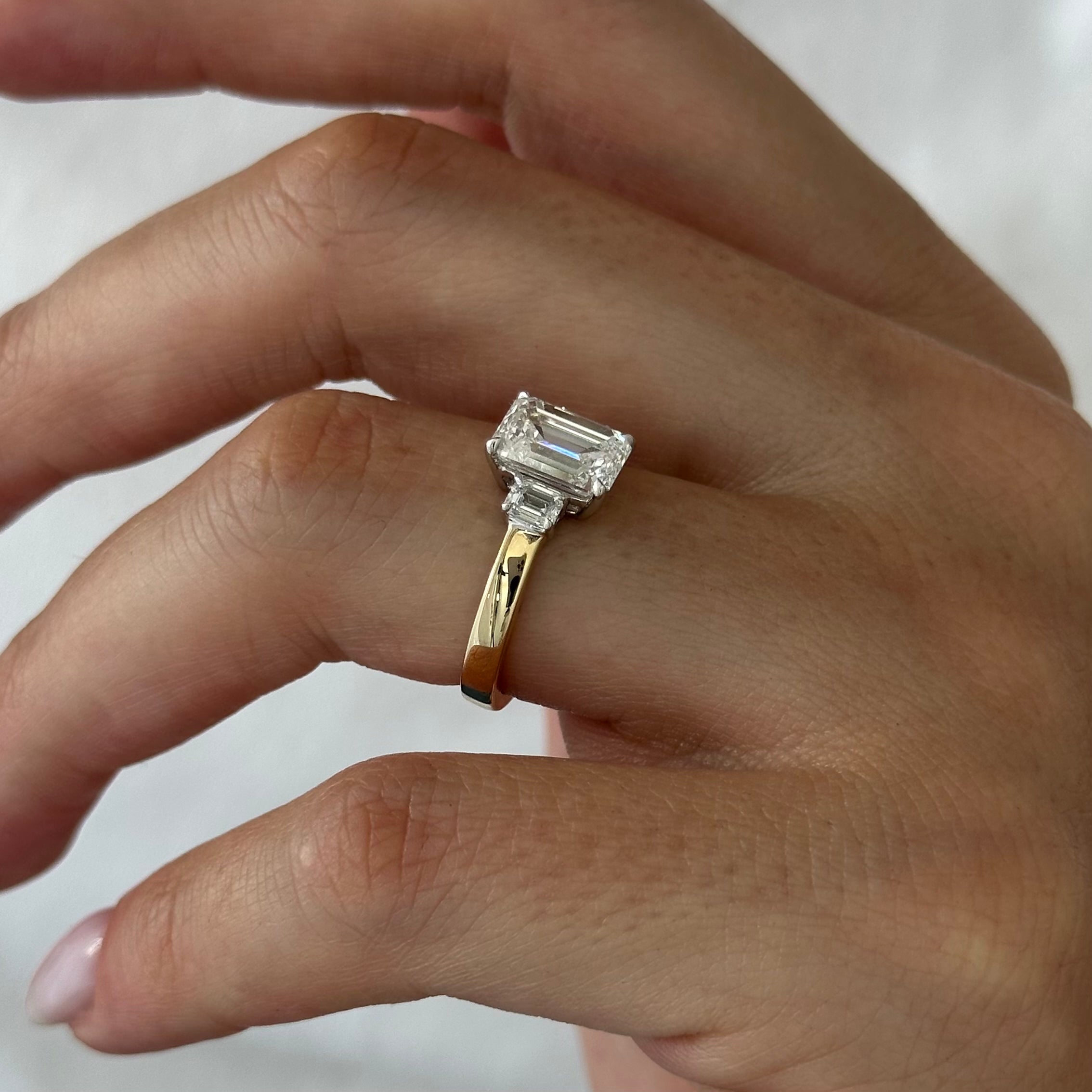 all-groups | 2.25 carat Emerald cut lab-grown diamond IGI certified, three stone engagement ring.