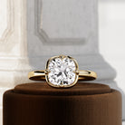 2 carat Cushion cut lab-grown diamond IGI certified, bezel engagement ring in 14K Yellow Gold.